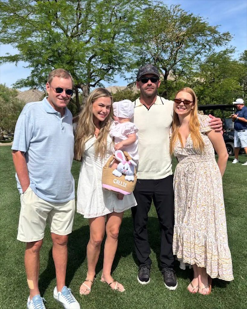 Devin Doyle with family members at an outdoor gathering on a golf course.